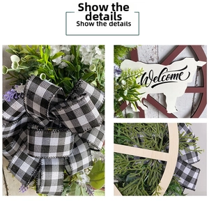 Detail view of farmhouse welcome wreath featuring checkered bow and cow-shaped wood sign