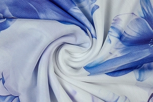 Detail of blue floral print mesh fabric showing translucent texture and soft drape