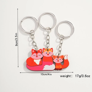 Detail of wooden fox family keychain set showing dimensions 9cm by 10cm and 17g weight