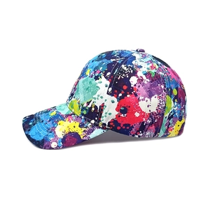 Detailed side view of colorful paint splatter baseball cap with artistic graffiti design