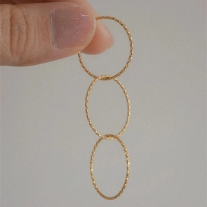 Three interlocking gold-plated rings with textured sandblast finish for a luxury look