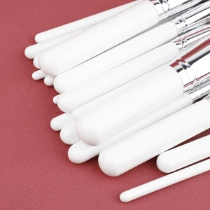 Detail of professional 30pcs makeup brush set with white handles and silver ferrules