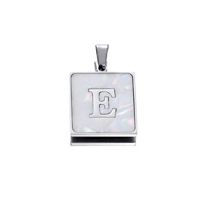 Detailed view of square silver pendant with iridescent shell inlay and letter E