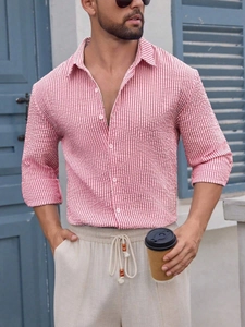 Detail of red and white seersucker striped shirt with textured cotton fabric