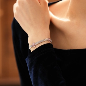 Detail of a sparkling zircon flower bracelet with pink and white rectangular stones