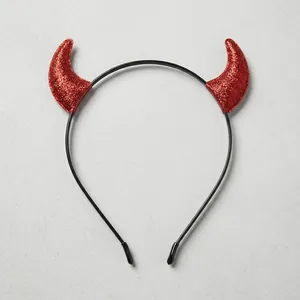 Top-view of Halloween glitter red devil horns headband measured with a ruler for size