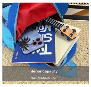 Internal capacity detail of cartoon schoolbag showing space for books and a ukulele