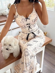 Close-up of ribbed knit camisole set with bear print and black bows in a home setting