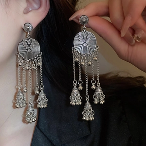 Vintage silver tassel earrings with round swirl texture and bohemian wind chimes
