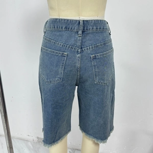 Back view of loose blue denim shorts with frayed hems and two classic rear pockets
