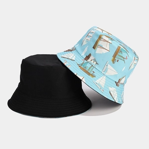 Detail of reversible sun hat showing classic black and blue vintage sailboat prints