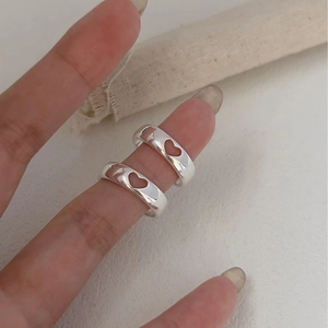 Minimalist 925 sterling silver hollow heart ring shown on model finger in silver finish