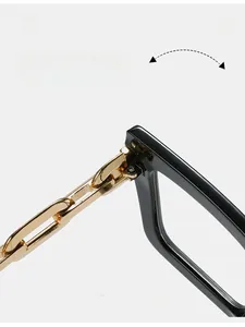 Detailed macro view of durable golden chain hinges on stylish oversized black frame glasses