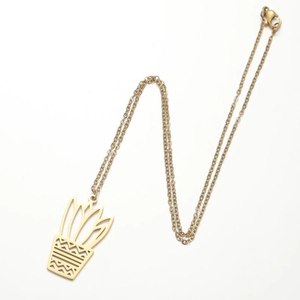 Detail of gold necklace featuring a minimalist hollowed-out potted plant pendant design