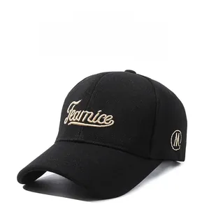 Detail of black baseball cap featuring Fearnice embroidery and breathable fabric texture