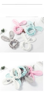 Detail of four colorful elastic headbands with cute rabbit ears in soft coral fleece