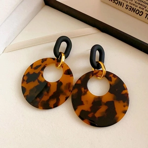 Vintage leopard resin hoop earrings with black U-shape studs and golden accents