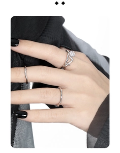 Close-up of S925 silver ring set with hollow diamond and irregular wave band design