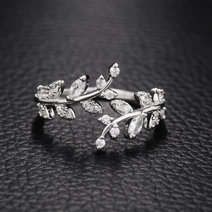 Silver leaf ring with sparkling crystals on black leather, adjustable open design