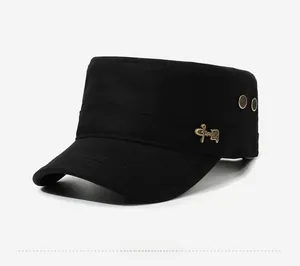 Detail of black cadet cap featuring gold calligraphy metal badge and decorative studs