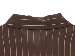 Detail shot of a dark brown striped shirt collar showing precise sewing craftsmanship