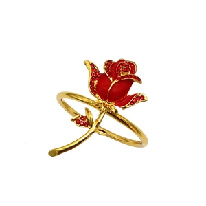 Macro detail of red rose napkin ring with gold stem and sparkling crystal petals