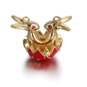 Detailed close-up of golden dual bunny rabbit pendant emerging from a red egg shell