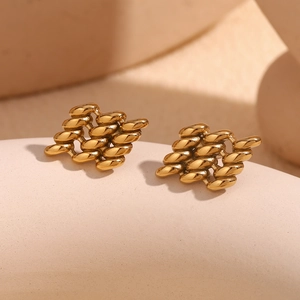 Detailed macro shot of 18K gold plated geometric woven earrings with intricate texture
