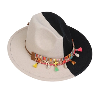 Close-up of wool fedora with gradient patchwork, woven band, and seashell pendants