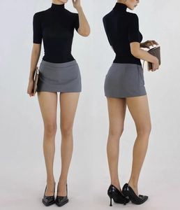 Detail view of the slim fit high neck top and mini skirt in studio lighting
