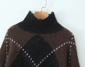 Detail of high neck sweater with brown and black argyle pattern and fuzzy mohair texture