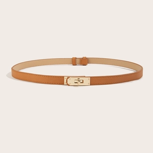 Close-up of tan saffiano leather belt with gold metal twist-lock buckle detail