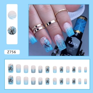 Blue and white gradient press-on nails with butterfly patterns and glitter sequins