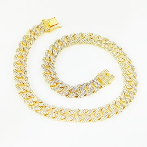 Detailed view of 15mm gold Cuban link chain with three rows of sparkling crystal stones