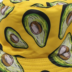 Close-up of vibrant yellow bucket hat with avocado print and precise brim stitching
