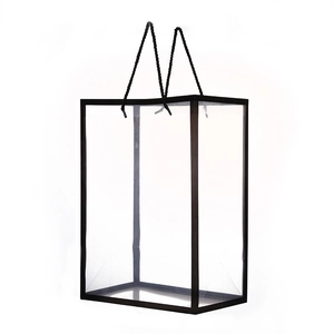 Detail view of transparent PVC flower gift bag with black reinforced frame and handles