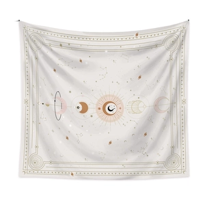 Detail of bohemian wall tapestry featuring moon phases, sun and celestial constellations
