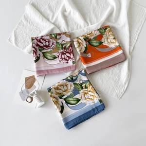 Colorful floral satin scarves in pink, orange, and blue with elegant silk texture