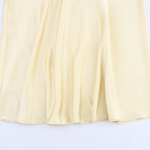 Detailed view of champagne satin fabric with elegant drape and smooth silky texture