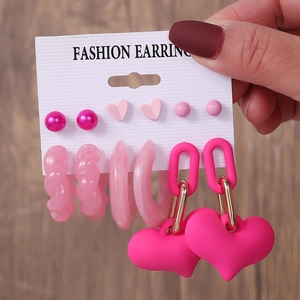 Detailed view of pink heart earring set featuring imitation pearls and sparkling studs