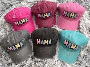 Detail of six vintage washed cotton baseball caps featuring colorful MAMA towel embroidery