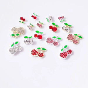Macro detail of cherry nail charms with rhinestones in various colors and sizes