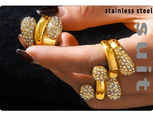 Macro detail of 18K gold-plated stainless steel jewelry set with teardrop zircon crystals