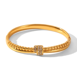 Detail of 18k gold plated stainless steel cuff with twisted rope and pavé zircon clasp