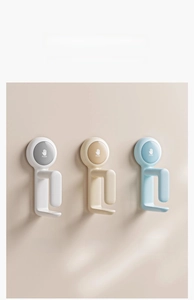 Wall-mounted basin hooks in grey, cream, and blue colors with push-to-lock design