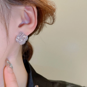 Macro shot of silver needle square stud earrings with pave-set cubic zirconia stones