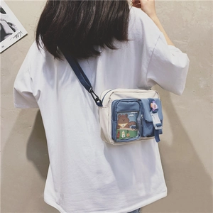 Detail showing the adjustable blue nylon strap and multi-pocket canvas crossbody bag