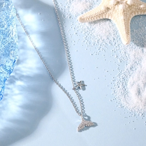 Detailed macro shot of S925 sterling silver fishtail necklace with star pendant