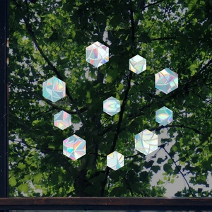 Detailed view of rainbow prismatic hexagon window film with holographic geometric pattern