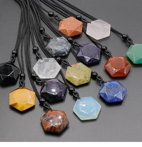 Macro shot of assorted hexagon-cut crystal pendants in vibrant multi-color natural stones